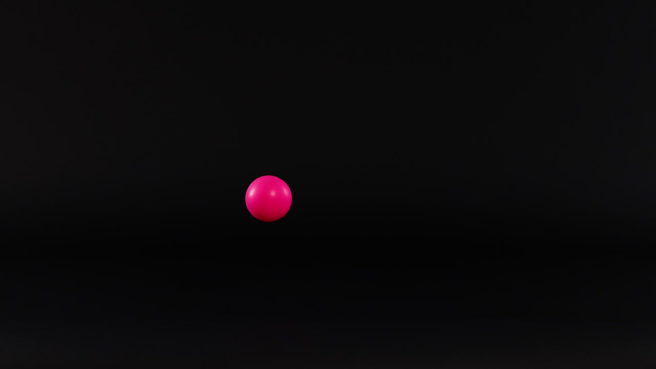 Pink ball bouncing against a dark background