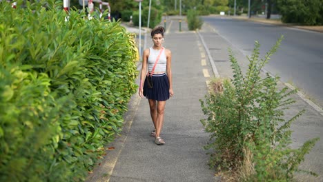 woman walking on city sidewalk