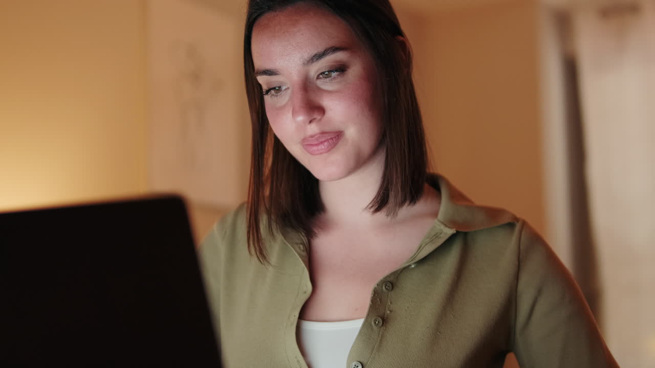 Woman Working From Home on Laptop at Night
