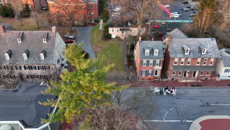 tourists ride in horse and carriage through bethlehem pa historic old town at christmas