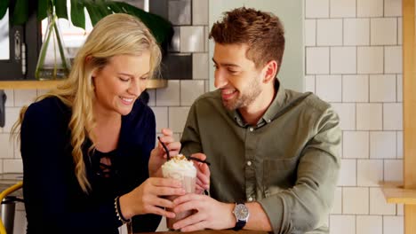 Affectionate-couple-sharing-milkshake-4k