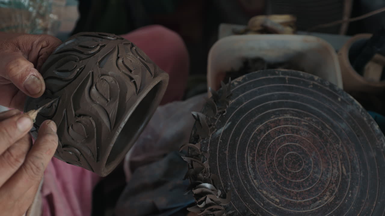 Hands Crafting a Decorated Clay Mug