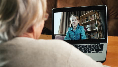 grandmother communicates to granddaughter by video link