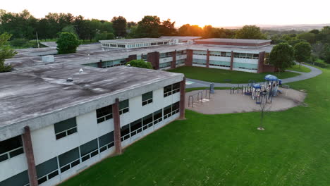 aerial sweeping shot of elementary school classrooms and playground