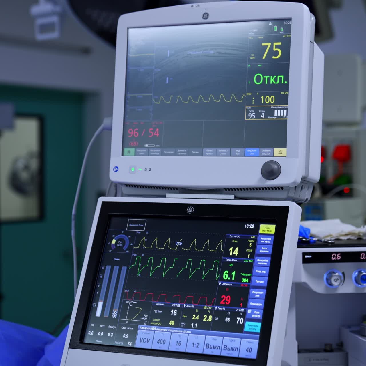 Advanced medical equipment with screens working during operation. Modern surgical room with four screens switched on. Blurred backdrop