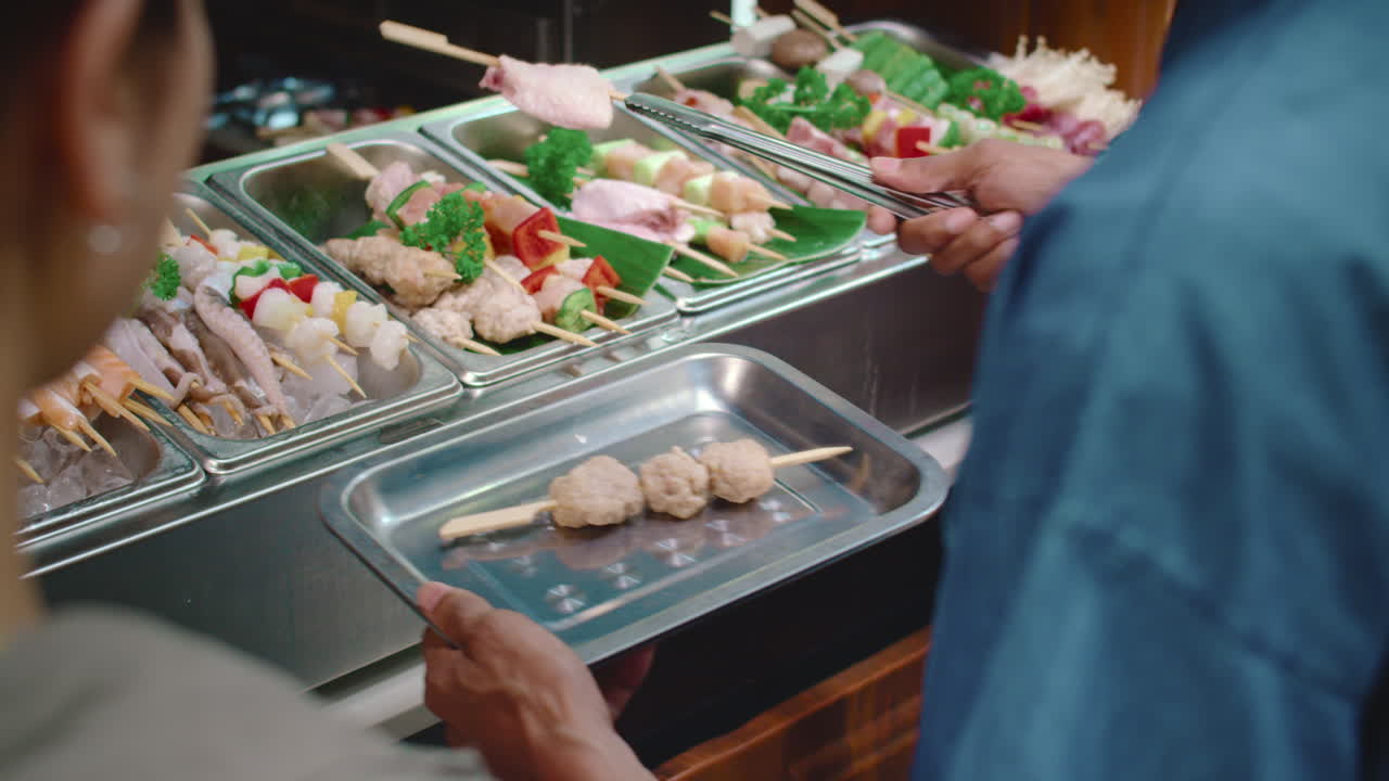 People Buying Skewers for Lunch at Street