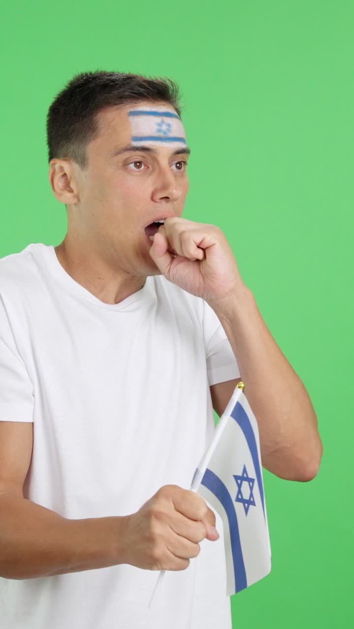 Nervous man cheering for Israel during a match looking away