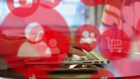 animation of multiple icons over cropped hands of caucasian man typing on keyboard of laptop