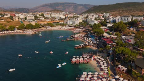 ksamil, albania, with crowded beaches and vibrant sea during summer, aerial view