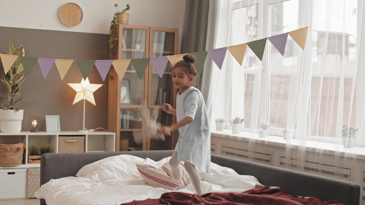 Little Girl Jumping on Bed