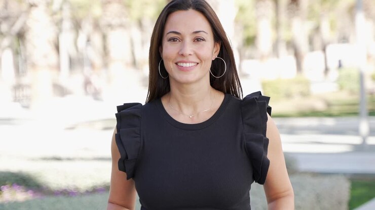 mujer sonriente en un parque de la ciudad