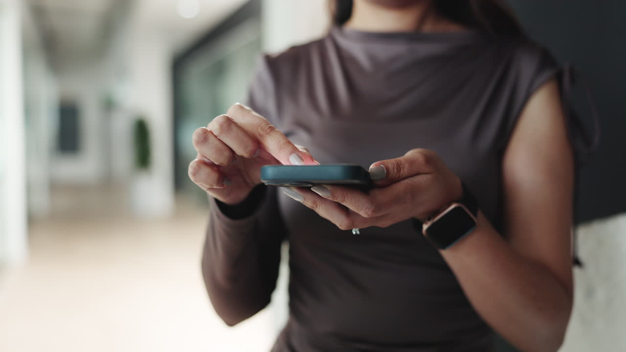 Close-up of Woman's Hands Using Smartphone in Office