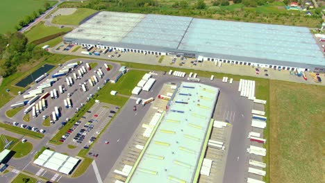 Aerial-view-of-warehouse-storages-or-industrial-factory-or-logistics-center-from-above