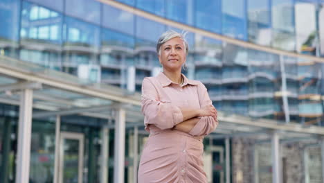 crossed arms, city and senior business woman