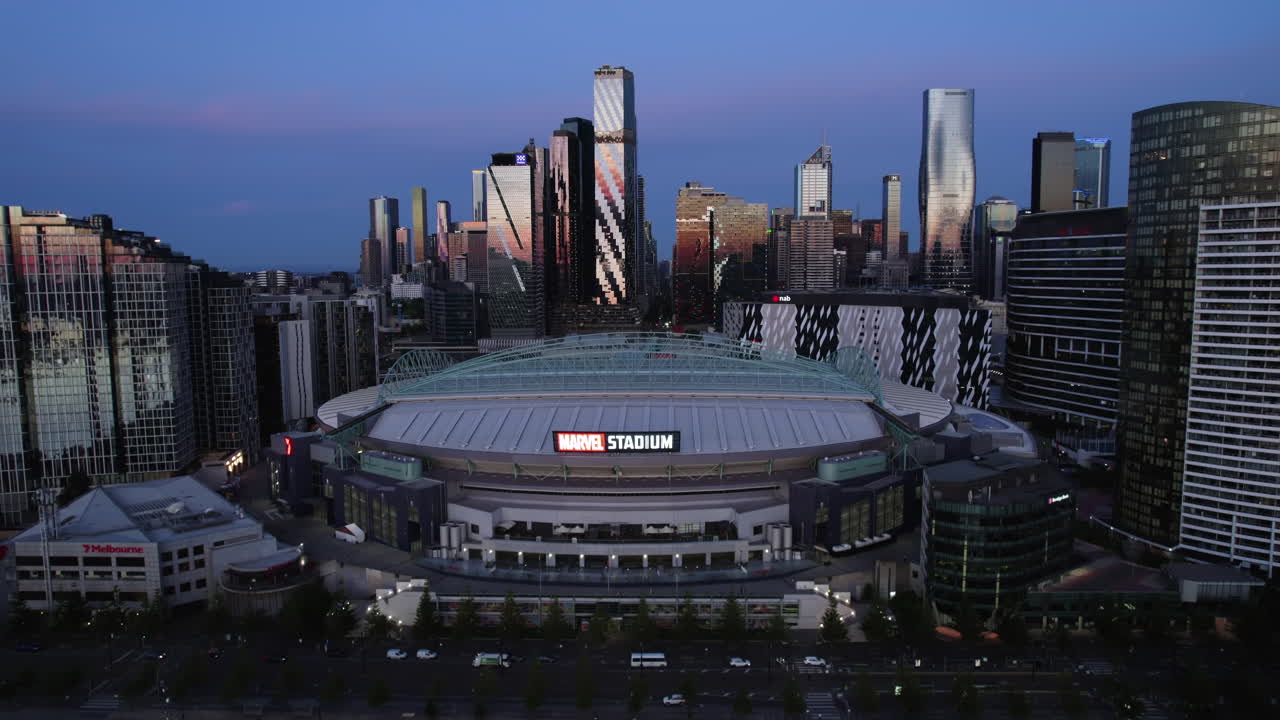 Drone rising in front of the Marvel stadium entrance, blue hour in Melbourne