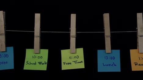 daily routine activities noted on colorful stickers hanged on wooden sticks