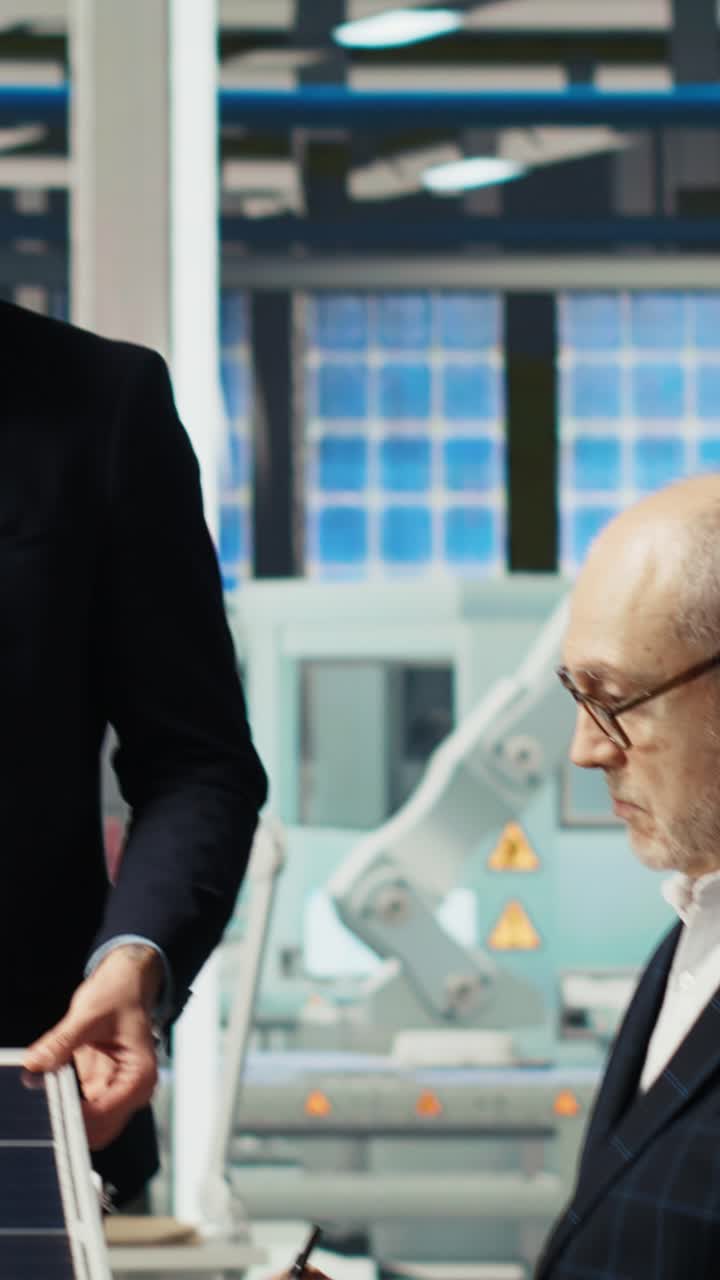 Vertical video Scientists in photovoltaics factory experimenting with advanced PV materials