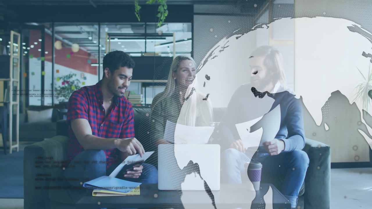 Diverse colleagues collaborating over documents with digital globe animation overlay
