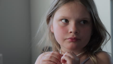 portrait of a young girl with a pearl necklace