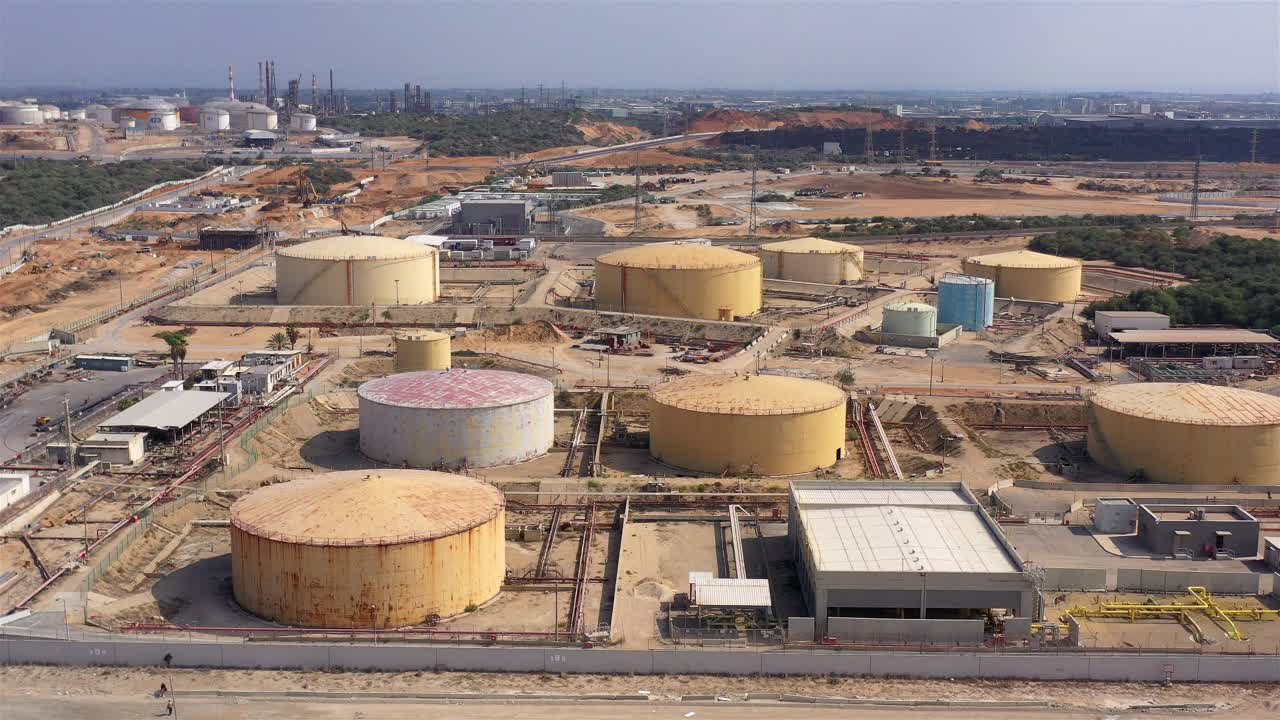 Aerial view of a large industrial complex with numerous storage tanks