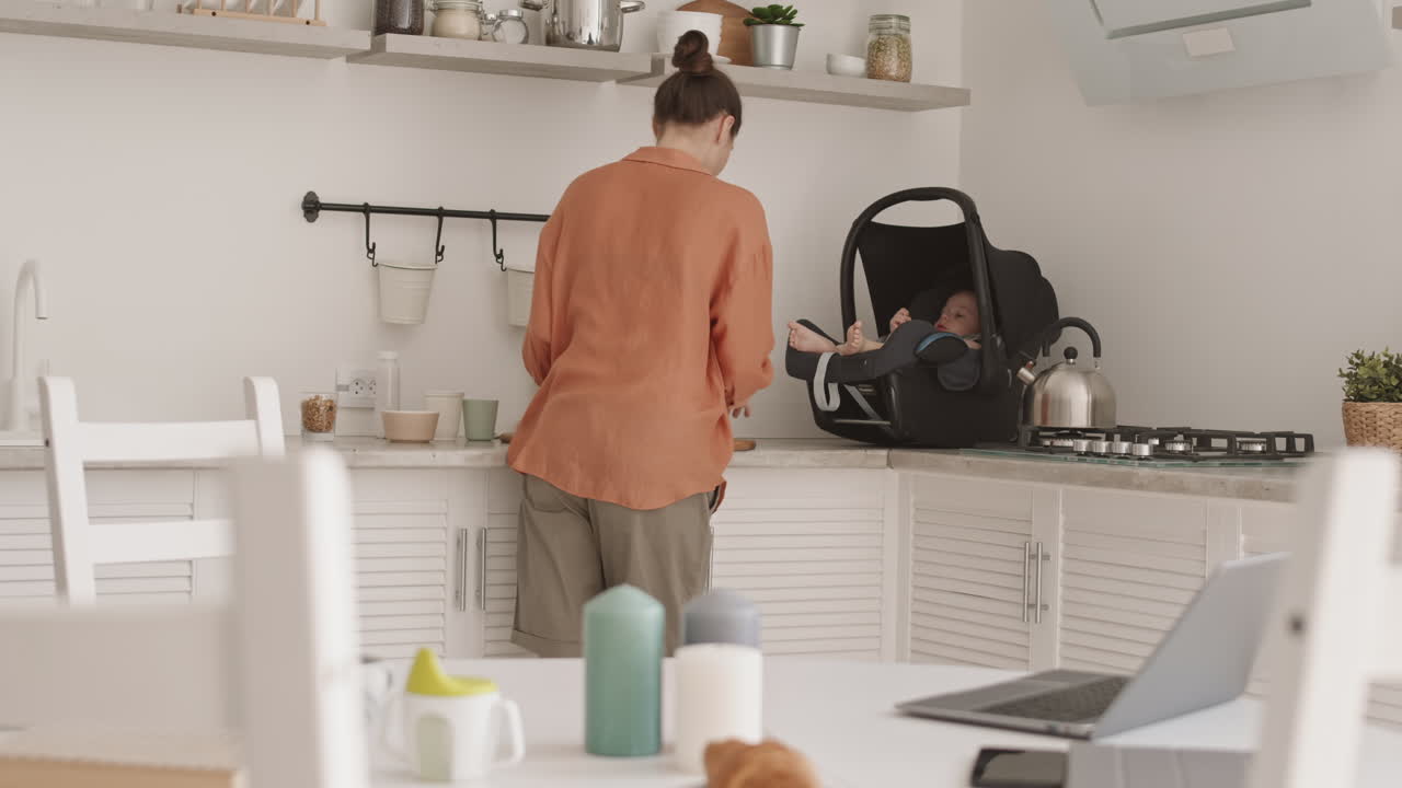 Businesswoman Cooking, Babysitting and Using Laptop
