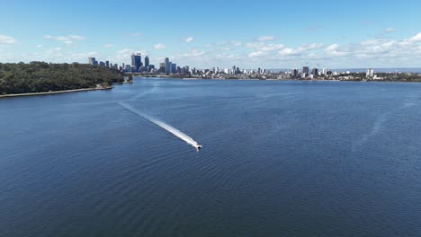 Lancha-Rápida-Pasando-Por-Drones-En-El-Río-Swan-En-Perth,-Australia-Occidental,-En-Un-Día-De-Cielo-Despejado