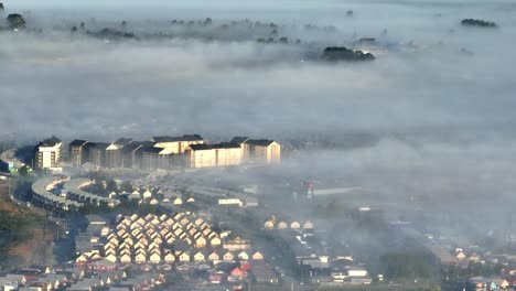 aerial view over puerto montt neighbourhoods with morning mist