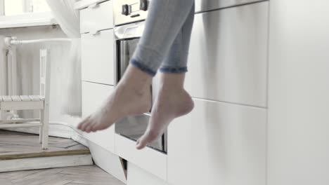 barefoot woman relaxing in kitchen