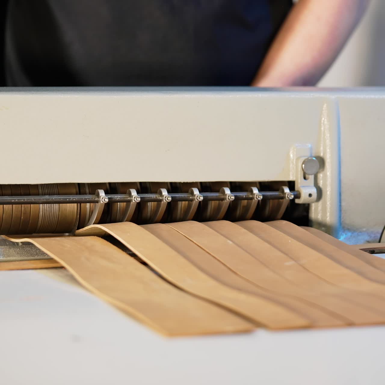 Process of sewing fabric tailor. Hands of woman using sewing machine in factory