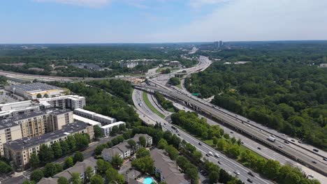 aerial shot pushing in on interstate 85 and ga 400 during a summer day in atlanta