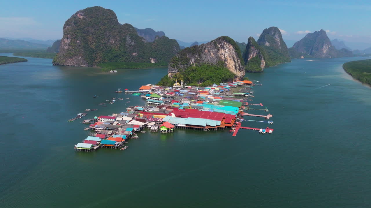 Floating Village Of Koh Panyee In The Strait of Malacca With Limestone Islands In Thailand. - aerial shot
