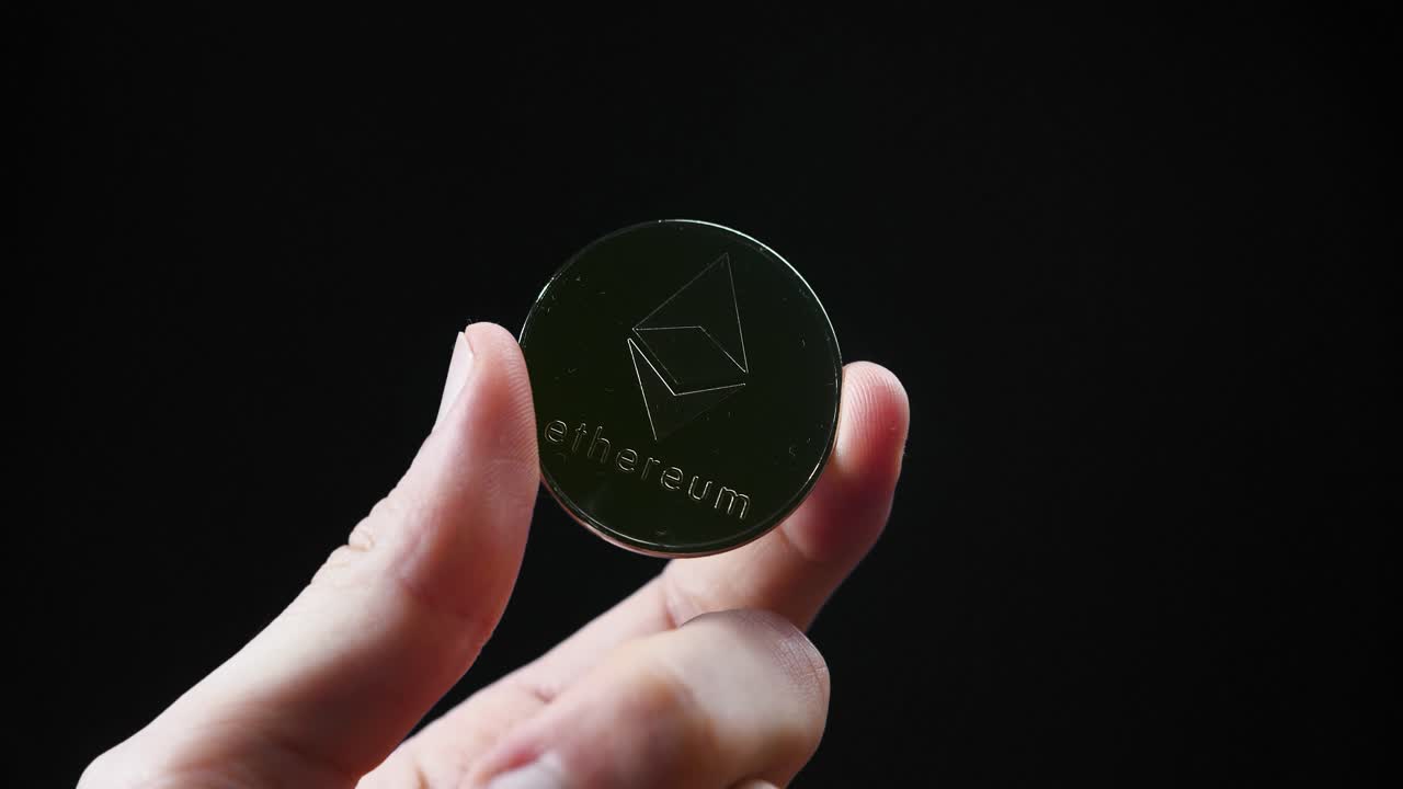 business investor hand holding a crypto coins cryptocurrency digital currency ethereum investment concept black studio background