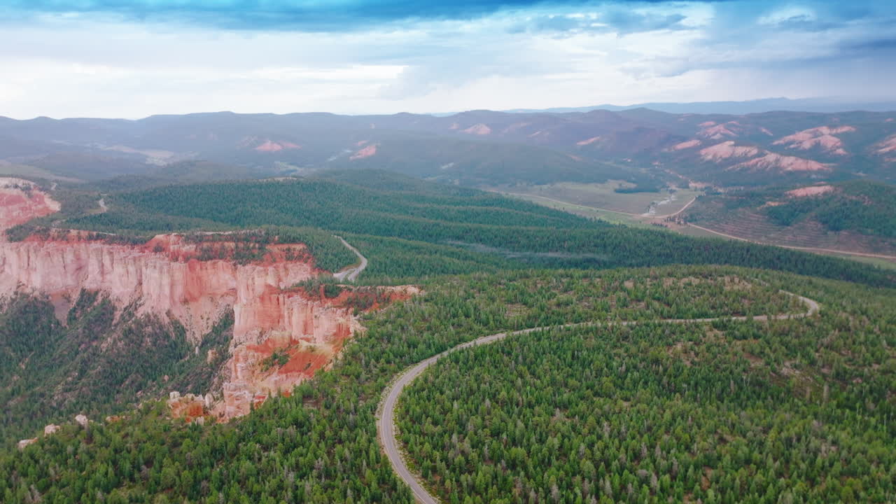 Lovely picture of pine woods covering the mountains in Zion National park, Utah, USA. Road passing through the forest on canyons. Aerial view.