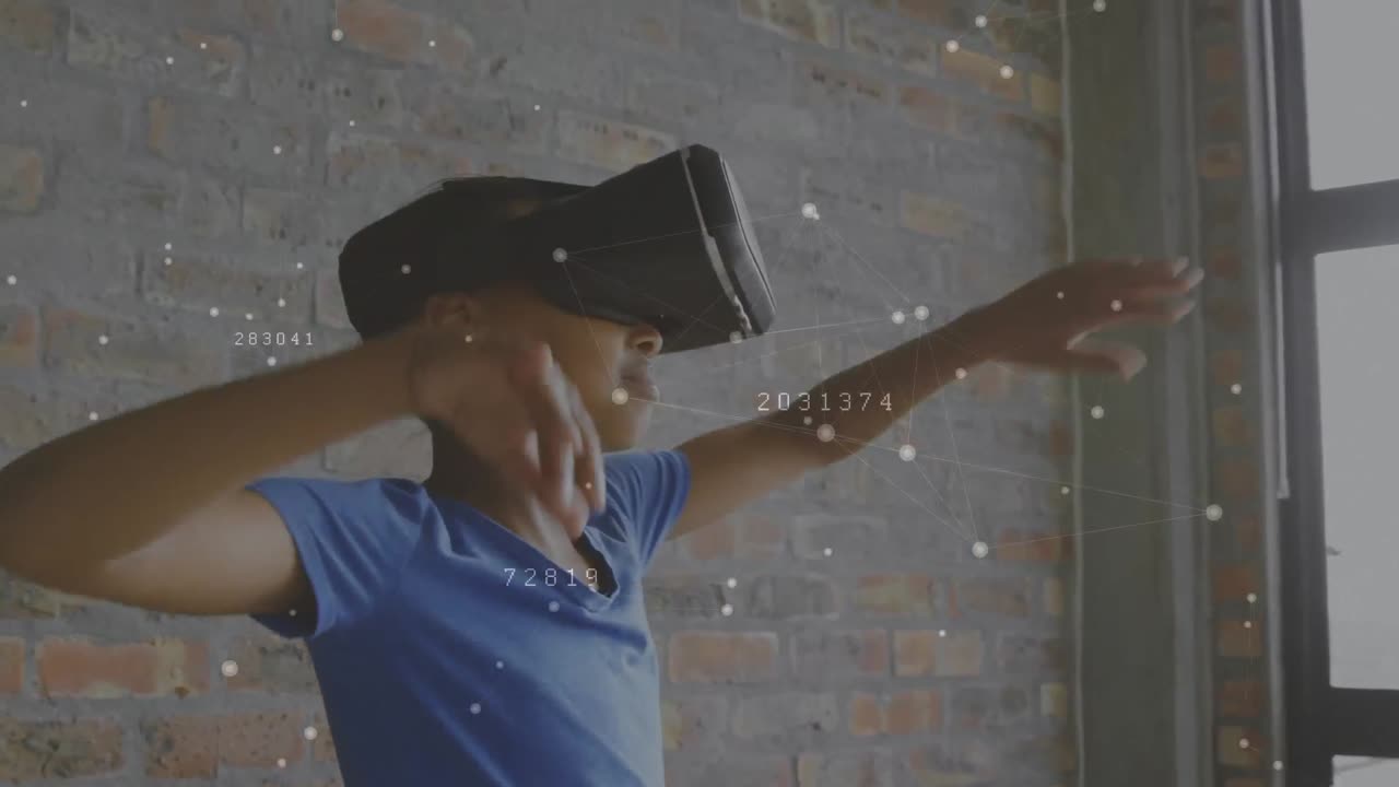 Boy wearing a virtual reality headset waving his arms