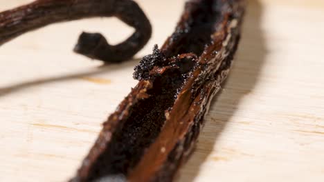 Tracking-out-along-Vanilla-dried-beans-on-Table,-Extreme-Macro-shot