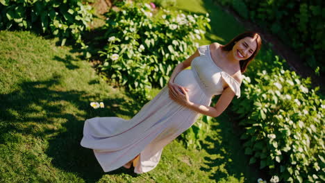 pregnant woman in a garden on a sunny day