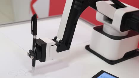 a modern robot draws a picture with a ballpoint pen a modern robot draws a picture with a ballpoint pen the robot teaches you how to draw modern technologies