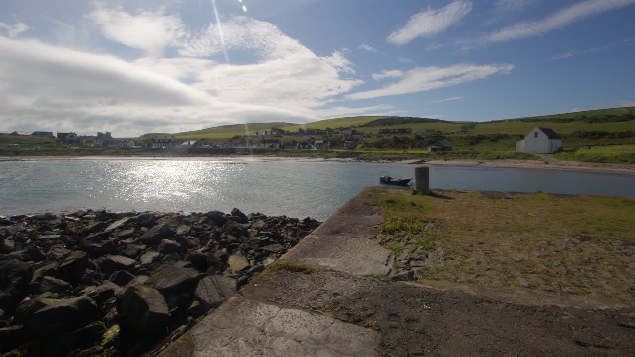 wide shot of the end of the harbour wall at port Logan bay.