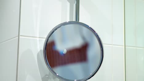 round washroom adjustable mirror on wall with the middle part isolated with clipping path