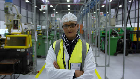 warehouse female worker looking at camera with arms crossed