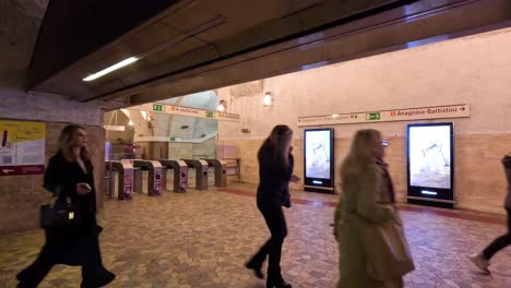 people walking through a metro station in rome