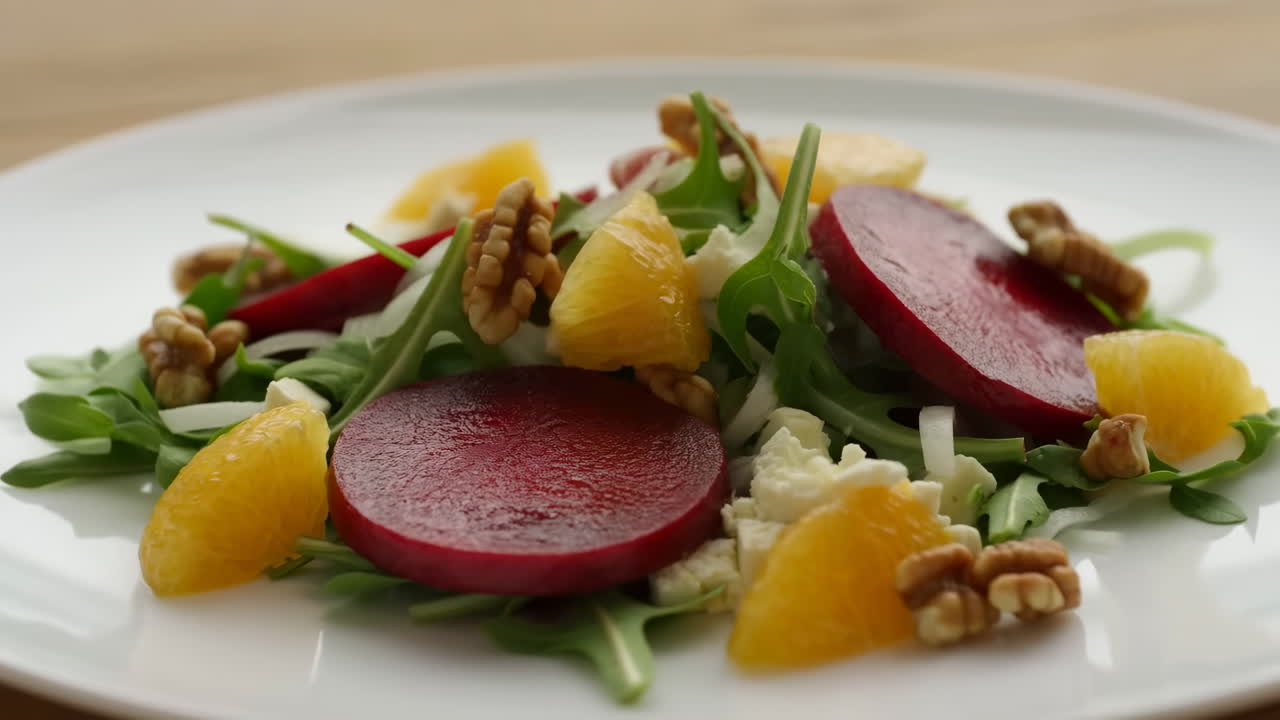 Fresh Beetroot Arugula Orange Salad Plated On White Dish, Vibrant Citrus Segments, Toasted Walnuts, Peppery