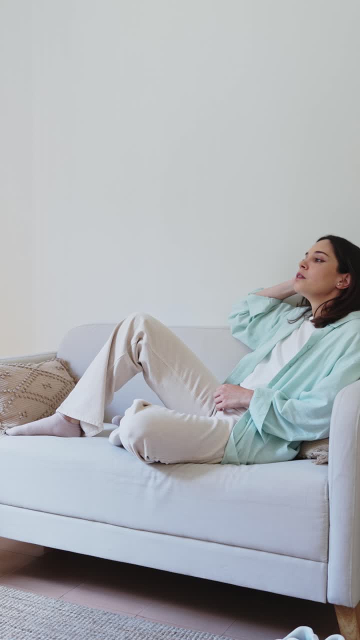 Giovane donna sdraiata sul divano che si sente stanca e stressata.