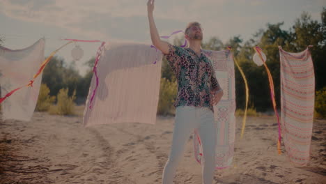 Smiling-man-dancing-to-music-while-grooving-at-beach