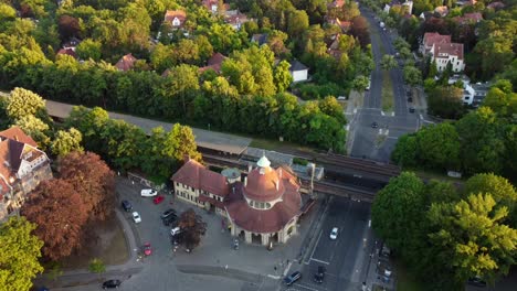 town villas area around the train station
great aerial view flight tilt up drone footage of mexikoplatz berlin zehlendorf golden hour summer 2022