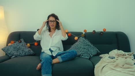 woman relaxing on sofa and woman with headache