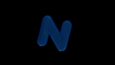 the letter n coming into focus on black background