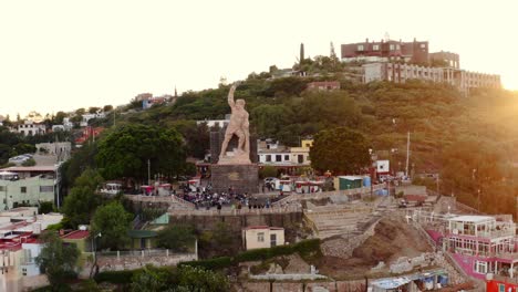 AERIAL:-Guanajuato-City-and-The-Pipila,-Sunset,-Mexico