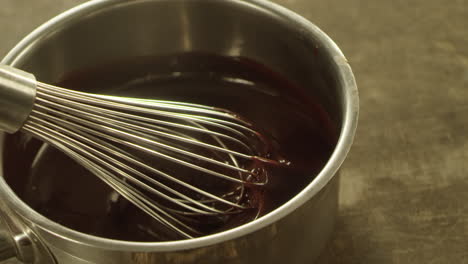 Closeup-chocolate-stream-falling-into-bowl-in-slow-motion.