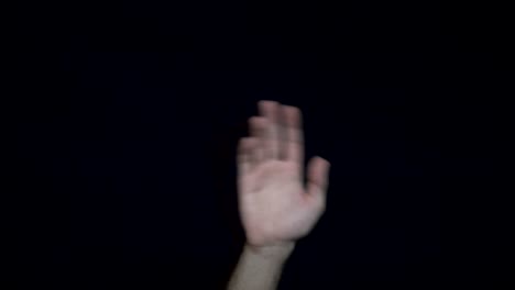 hand gesture against black background